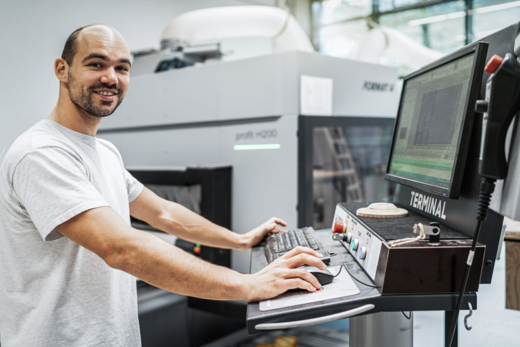 a man standing in front of a computer